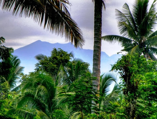 Mount Agung the holy mountain of Bali, as seen from the garden of Villa Sabandari, a botique hotel in Ubud, Bali